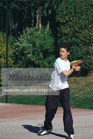 Boy playing tennis