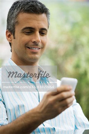 Man text messaging with cell phone