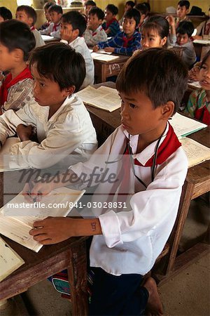 Portrait of children in school uniform sitting at desks in a school classroom in North Vietnam, Indochina, Southeast Asia, Asia