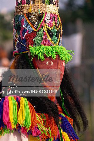 Head and shoulders portrait of a person wearing mask headdress and brightly coloured costume, Gombey, island of Bermuda, Atlantic, Central America