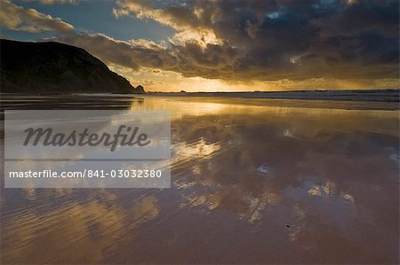 Sunset reflected in tidal wash, Praia do Castelejo beach near Vila do Bispo, Algarve, Portugal, Europe