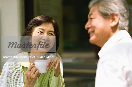 Older Couple Talking over Cup of Coffee