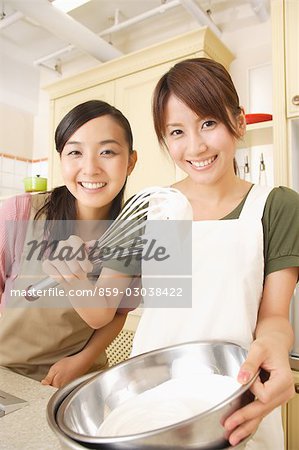 Front view of women whisking cream