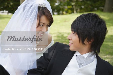 Bride and Groom Laying on Grass