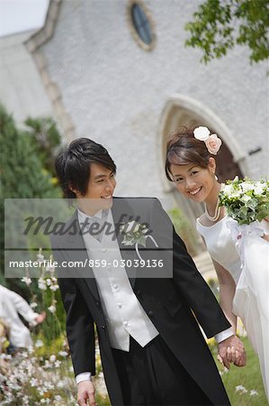 Bride and Groom Walking in Garden