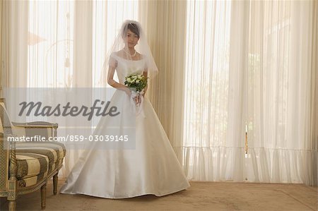 Japanese Bride Standing with Flower Bouquet