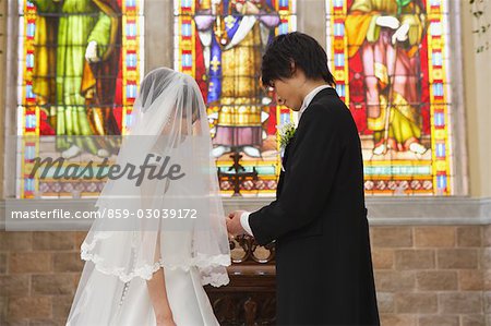 Groom Putting the Ring on his Brides finger