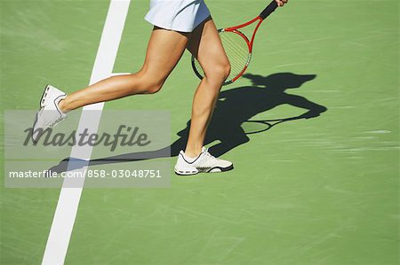 Tennis Player Hitting Ball