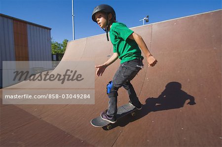 Boy skating  with skateboard in skate park