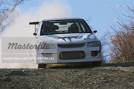 Rally car and clouds of dust