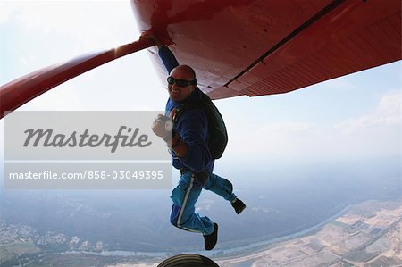 Man hanging on plane
