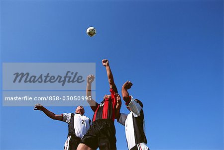 Soccer Players Heading the Ball