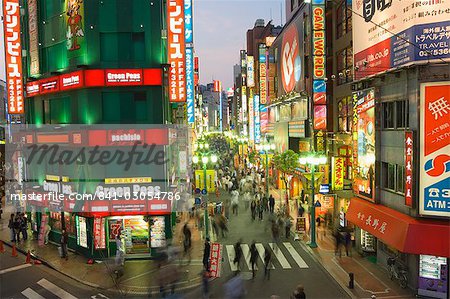 Busy streets and neon signs in the evening at Shinjuku station, Shinjuku, Tokyo, Japan, Asia