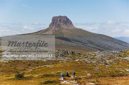 Hikers walking towards Barn Bluff on the overland track in Cradle Mountain Lake St. Clair National Park, part of Tasmanian Wilderness, UNESCO World Heritage Site, Tasmania, Australia, Pacific Hikers walking towards Barn Bluff on the overland track in Cradle Mountain Lake St. Clair National Park, part of Tasmanian Wilderness, UNESCO World Heritage Site, Tasmania, Australia, Pacific