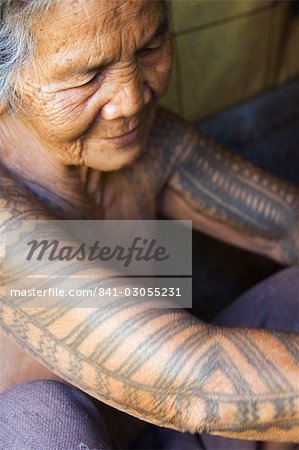 Old woman with traditional tattoo on arms in local home, Liglig Headhunters Village, Tinglayan Town, The Cordillera Mountains, Kalinga Province, Luzon, Philippines, Southeast Asia, Asia