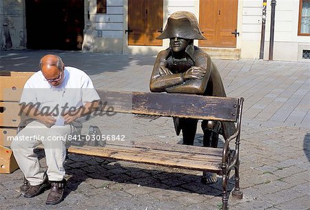 Man on park bench and statue of Napoleon, Hlavne Square, Bratislava, Slovakia, Europe