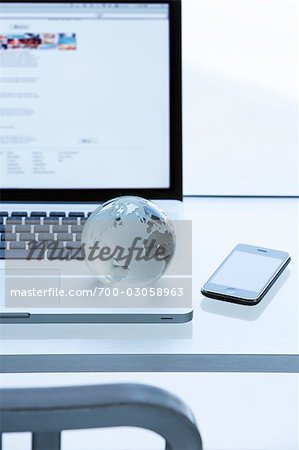 Glass Globe, iPhone and Laptop Computer