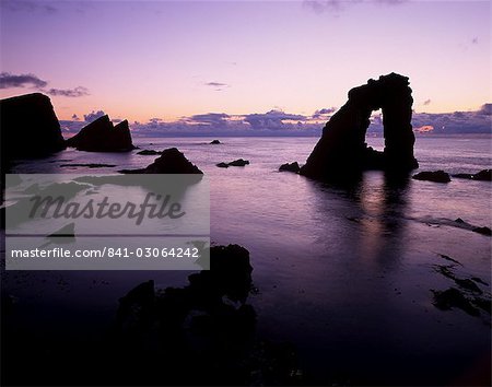 Gaada Stack natural arch, 45 m high, at sunset, Foula, Shetland Islands, Scotland, United Kingdom, Europe