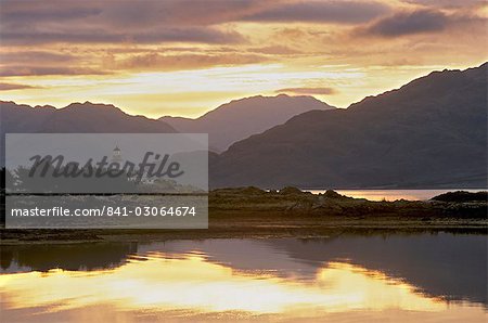 Sunrise over Isleornsay and lighthouse, Knoydart mountains behind, Isle of Skye, Inner Hebrides, Scotland, United Kingdom, Europe