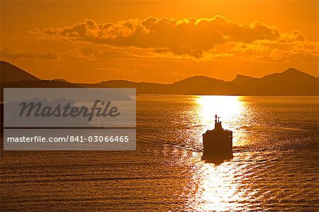 Cruise ship sails into sunset, Port of Dubrovnik, Dalmatia, Croatia, Europe