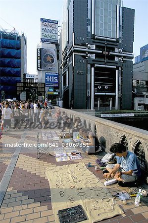 Pedestrian bridge with street traders on the Dotombori River in Minami, city centre district, Osaka, Japan, Asia