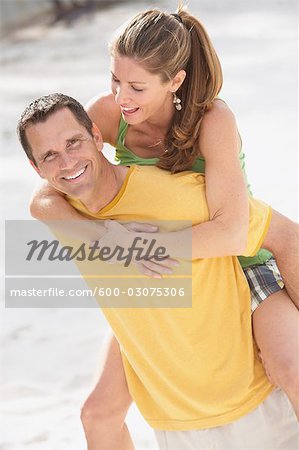 Man Carrying Woman on Back, Having Fun