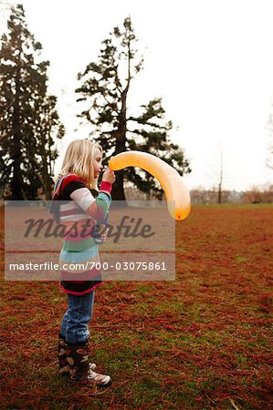 Girl Blowing up Balloon