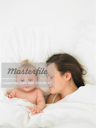 baby and mother in bed