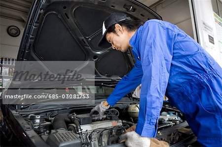 Mechanic maintaining car