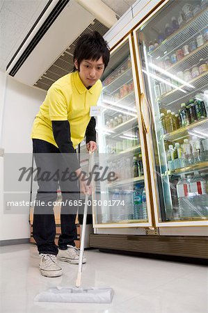 Convenience store clerk cleaning up store
