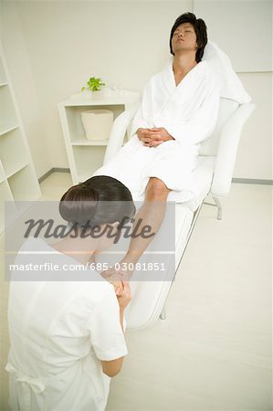 Young man receiving foot massage