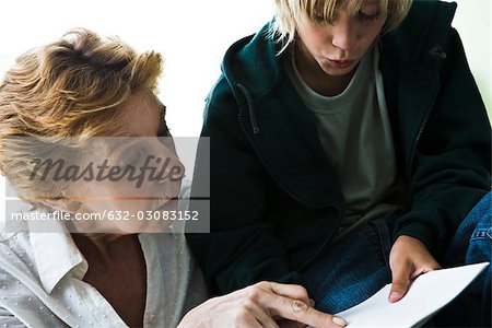 Grandmother helping grandson with homework