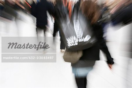 Shopper carrying shopping bag, blurred