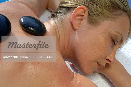 Hot stone massage - woman on the massage table