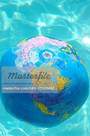 Globe beach ball swimming in the water