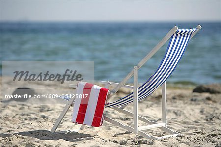 Blue and white deckchair on the beach