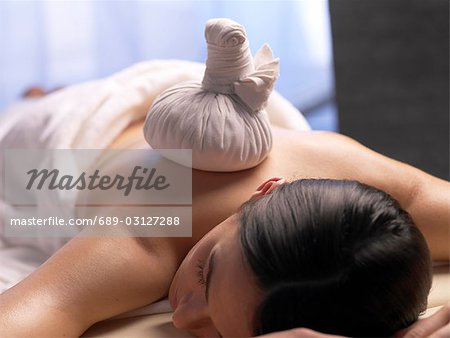 Woman get a massage with a compress