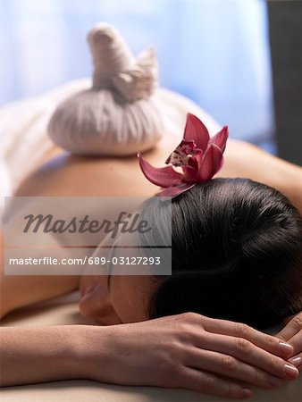 Woman getting a massage with a compress