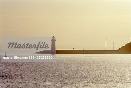 At the sea: Lighthouse in sunset
