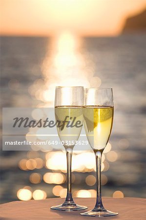 Two glasses of champagne at sunset