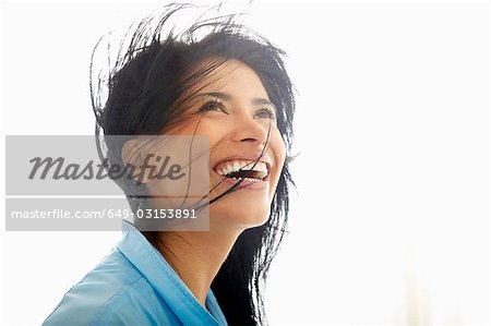 Woman with wind in her hair, smiling