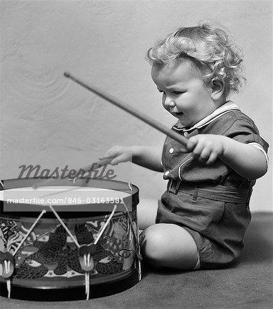 1930s CHILD PLAYING DRUM DRUMMING MUSIC