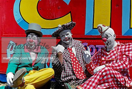 1970s THREE CIRCUS CLOWNS IN COLORFUL COSTUMES AND HATS