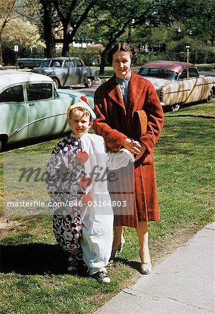 1950s MOTHER WITH SON DRESSED IN CLOWN SUIT OUTDOORS