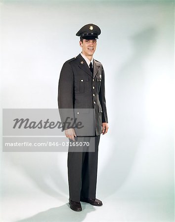 1960s FULL LENGTH PORTRAIT STANDING SOLDIER SMILING ARMY UNIFORM