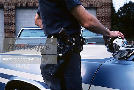 1970s DETAIL OF POLICE OFFICERS HIP WITH BELT GUN AND HOLSTER