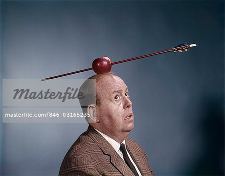 1960s ANXIOUS NERVOUS MAN LOOKING UP AT ARROW IN APPLE TARGET TOP HIS HEAD SYMBOL WILLIAM TELL HUMOR