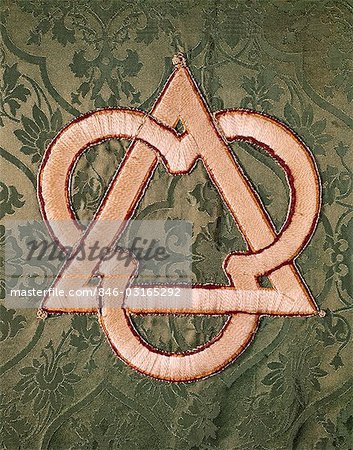 SYMBOL OF HOLY TRINITY EMBROIDERED ON GREEN FABRIC