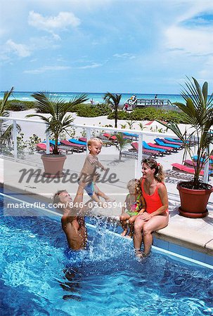 FAMILY PLAYING IN POOL