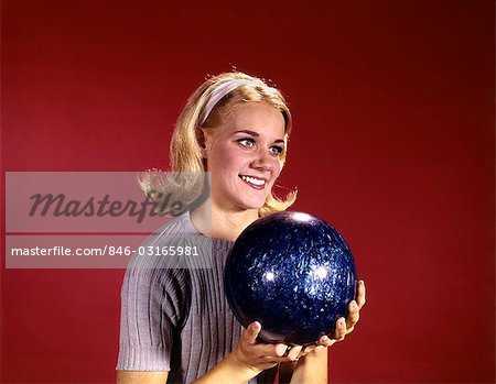 1960s YOUNG BLOND WOMAN HOLDING BOWLING BALL WEARING BLUE SWEATER